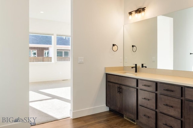 1609 Wyatt Earp Ct, Belgrade, MT 59714 - bathroom featuring wood finished floors, vanity, and baseboards