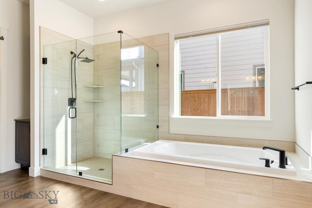 1609 Wyatt Earp Ct, Belgrade, MT 59714 - bathroom featuring a bath, a stall shower, and wood finished floors
