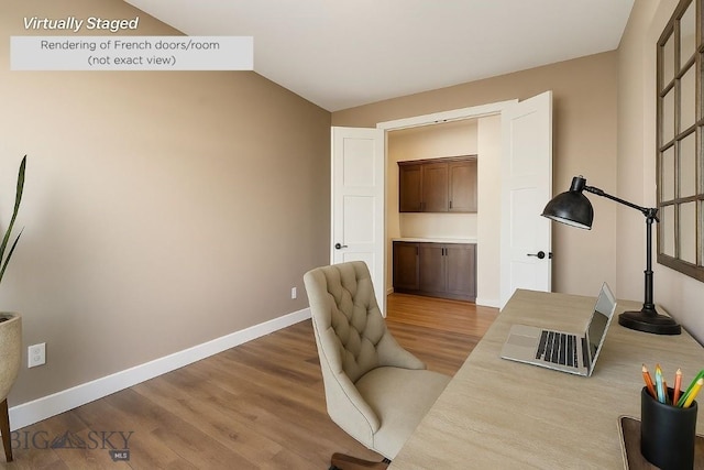 1609 Wyatt Earp Ct, Belgrade, MT 59714 - office featuring wood finished floors, baseboards, and lofted ceiling