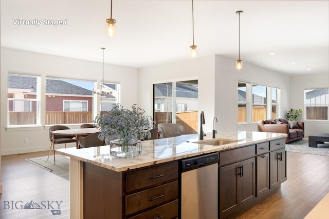 1609 Wyatt Earp Ct, Belgrade, MT 59714 - kitchen with stainless steel dishwasher, a sink, light wood-type flooring, dark brown cabinetry, and recessed lighting