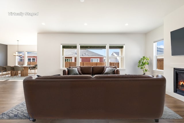 1609 Wyatt Earp Ct, Belgrade, MT 59714 - living area featuring a chandelier, a glass covered fireplace, dark wood finished floors, and recessed lighting