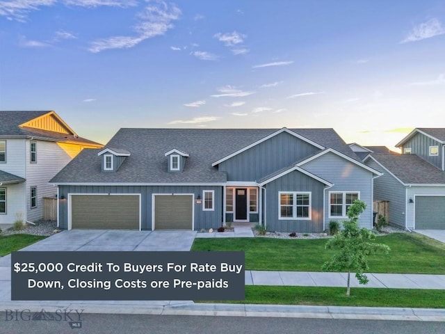1609 Wyatt Earp Ct, Belgrade, MT 59714 - view of front facade featuring board and batten siding, an attached garage, driveway, a shingled roof, and a front lawn