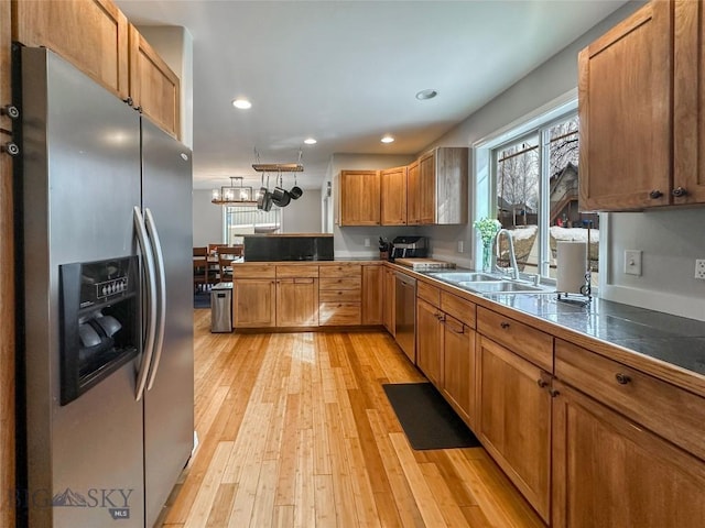 4442 Alexander, Bozeman, MT 59718 - kitchen featuring appliances with stainless steel finishes, a sink, light wood finished floors, recessed lighting, and a peninsula