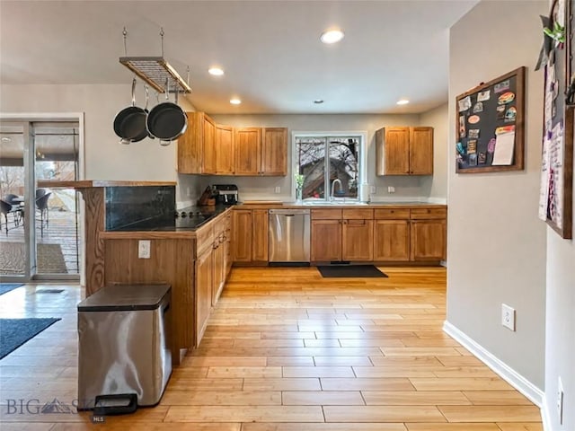 4442 Alexander, Bozeman, MT 59718 - kitchen featuring stainless steel dishwasher, light wood-type flooring, a sink, a peninsula, and brown cabinets