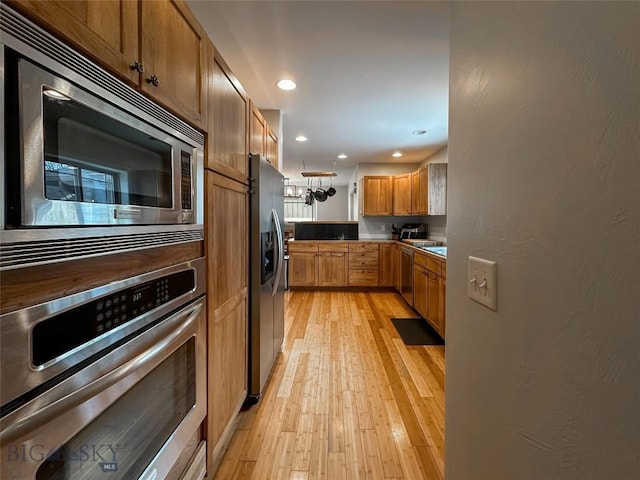 4442 Alexander, Bozeman, MT 59718 - kitchen with appliances with stainless steel finishes, light wood finished floors, recessed lighting, and brown cabinets