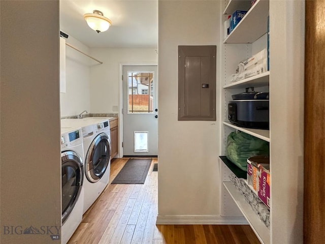 4442 Alexander, Bozeman, MT 59718 - washroom with electric panel, cabinet space, separate washer and dryer, light wood-type flooring, and baseboards
