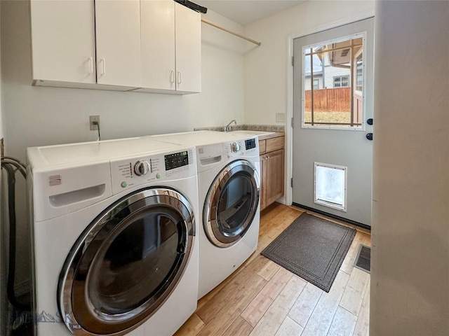 4442 Alexander, Bozeman, MT 59718 - laundry room with independent washer and dryer, cabinet space, and light wood finished floors