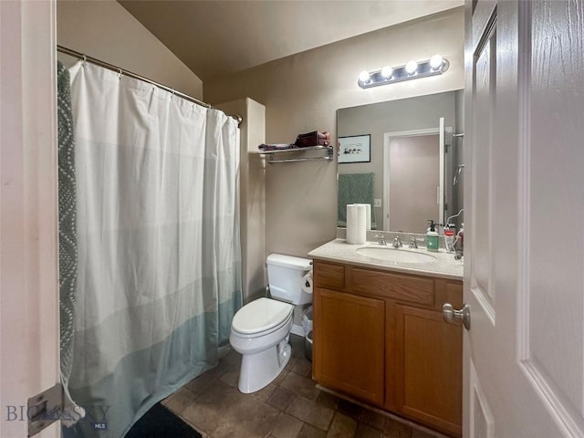 4442 Alexander, Bozeman, MT 59718 - bathroom featuring toilet, vanity, stone finish floors, a shower with shower curtain, and vaulted ceiling