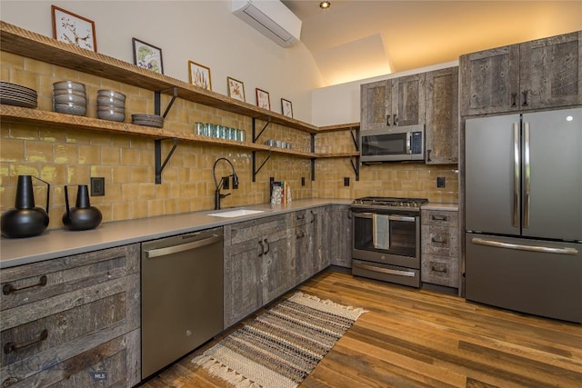 5933 Monforton School Rd, Bozeman, MT 59718 - kitchen with appliances with stainless steel finishes, a wall mounted air conditioner, open shelves, a sink, and decorative backsplash