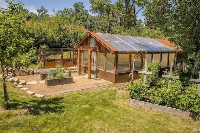 5933 Monforton School Rd, Bozeman, MT 59718 - view of green lawn featuring an exterior structure, an outbuilding, and a vegetable garden