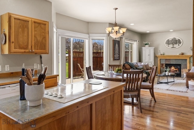 126 Pathfinder Trl, Bozeman, MT 59718 - dining room with light wood finished floors, a chandelier, a fireplace, and recessed lighting