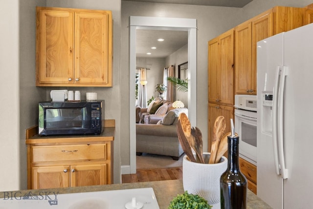 126 Pathfinder Trl, Bozeman, MT 59718 - kitchen featuring white appliances, wood finished floors, and recessed lighting