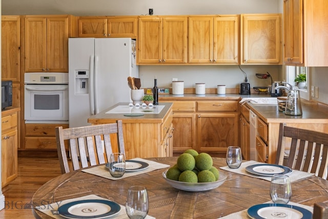 126 Pathfinder Trl, Bozeman, MT 59718 - kitchen featuring white appliances, wood finished floors, and a center island