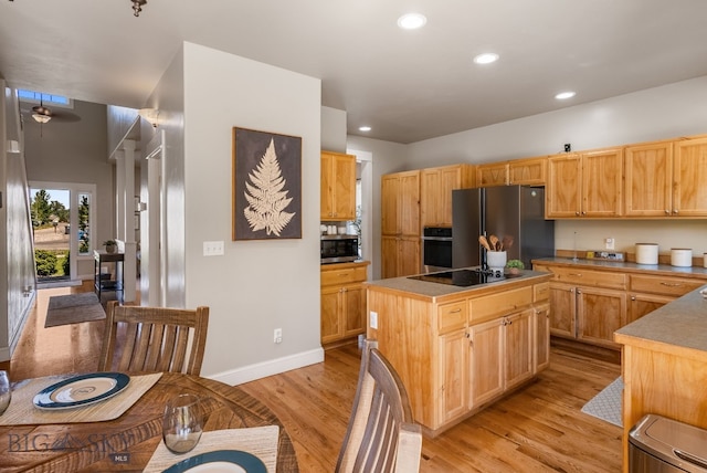 126 Pathfinder Trl, Bozeman, MT 59718 - kitchen featuring stainless steel appliances, light wood-style floors, a kitchen island, and recessed lighting