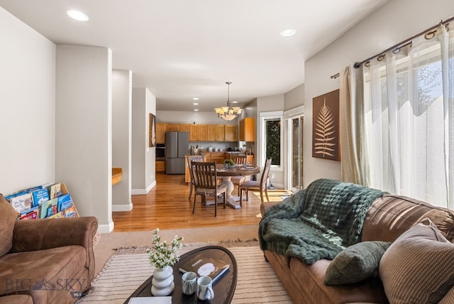 126 Pathfinder Trl, Bozeman, MT 59718 - living room featuring a chandelier, light wood-style flooring, and recessed lighting