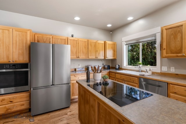 126 Pathfinder Trl, Bozeman, MT 59718 - kitchen featuring appliances with stainless steel finishes, light wood finished floors, recessed lighting, and light countertops