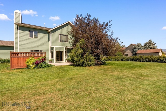 126 Pathfinder Trl, Bozeman, MT 59718 - back of property with a chimney, a yard, and a patio area
