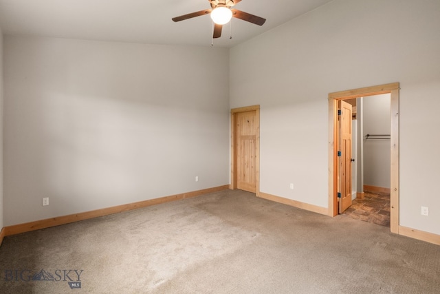 1025 Advance Dr, Bozeman, MT 59718 - unfurnished bedroom featuring carpet, high vaulted ceiling, a ceiling fan, and a walk in closet