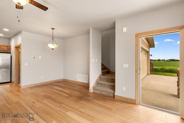 1025 Advance Dr, Bozeman, MT 59718 - unfurnished living room with light wood-type flooring, a ceiling fan, stairway, and recessed lighting