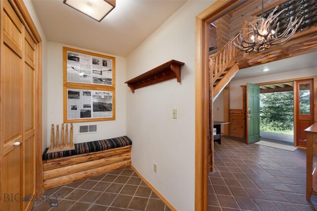 2415 Crazy Horse Rd, Big Sky, MT 59716 - corridor featuring a chandelier and baseboards