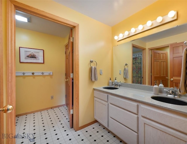 2415 Crazy Horse Rd, Big Sky, MT 59716 - bathroom featuring double vanity and baseboards