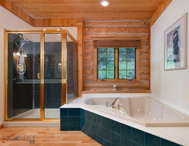 2415 Crazy Horse Rd, Big Sky, MT 59716 - full bath with rustic walls, wood ceiling, a stall shower, a jetted tub, and wood finished floors