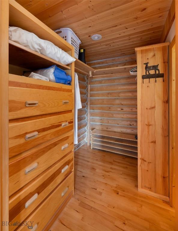 2415 Crazy Horse Rd, Big Sky, MT 59716 - walk in closet with light wood-type flooring