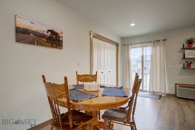 511 W Hugel, Ennis, MT 59729 - dining space with wood finished floors, baseboards, a wall mounted AC, and recessed lighting