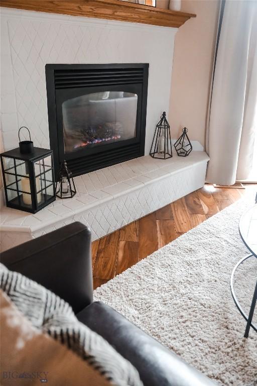 56 Green Belt Dr, Belgrade, MT 59714 - detailed view of wood finished floors and a glass covered fireplace