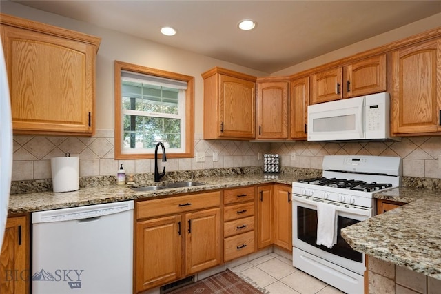 56 Green Belt Dr, Belgrade, MT 59714 - kitchen with white appliances, a sink, light stone counters, decorative backsplash, and recessed lighting