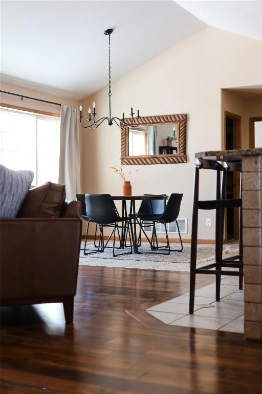 56 Green Belt Dr, Belgrade, MT 59714 - dining space with lofted ceiling, wood finished floors, and baseboards