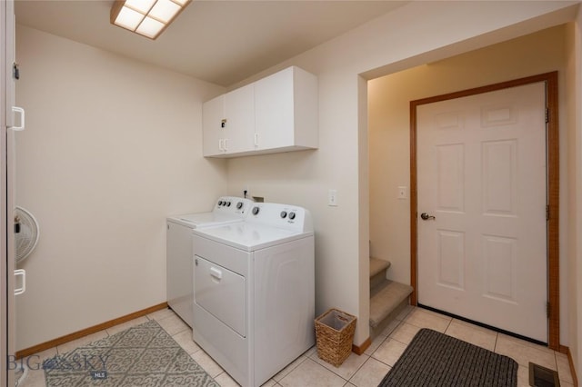56 Green Belt Dr, Belgrade, MT 59714 - washroom with independent washer and dryer, cabinet space, light tile patterned floors, and baseboards