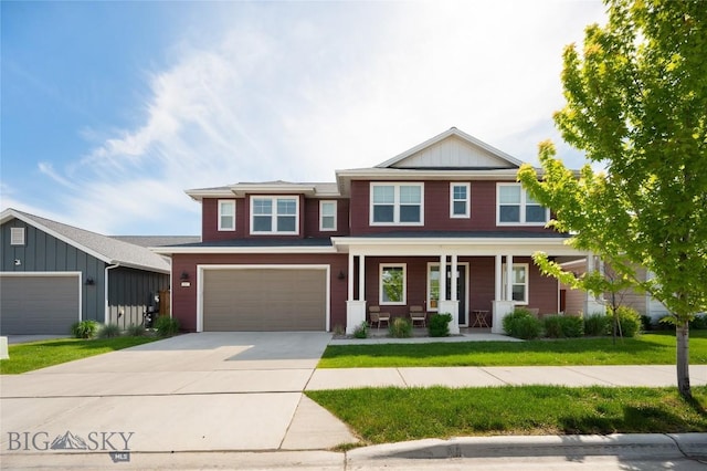 810 Butler Crk, Belgrade, MT 59714 - view of front facade featuring covered porch, driveway, a garage, and a front yard