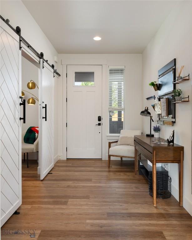 810 Butler Crk, Belgrade, MT 59714 - foyer featuring a barn door, light wood-type flooring, and recessed lighting