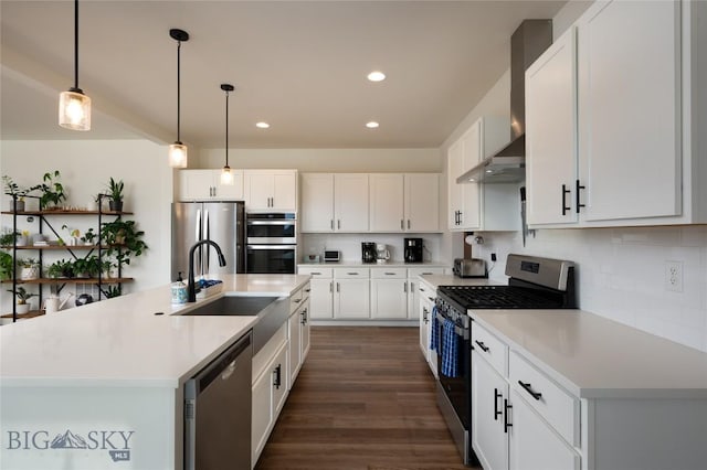 810 Butler Crk, Belgrade, MT 59714 - kitchen with appliances with stainless steel finishes, wall chimney range hood, backsplash, recessed lighting, and decorative light fixtures