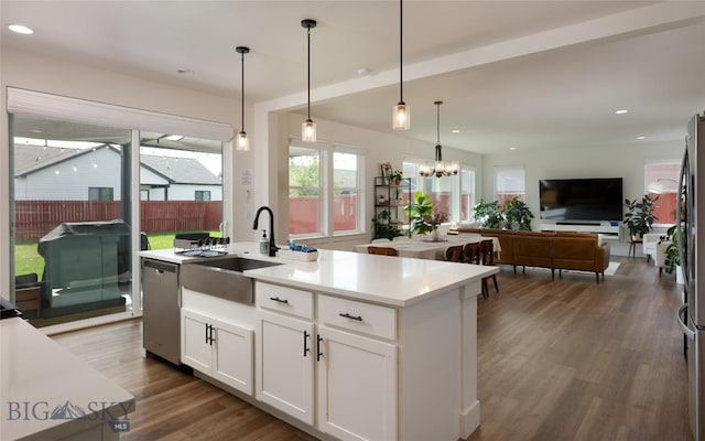 810 Butler Crk, Belgrade, MT 59714 - kitchen featuring dishwasher, an island with sink, light countertops, white cabinetry, and open floor plan