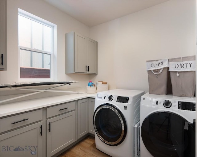 810 Butler Crk, Belgrade, MT 59714 - laundry area featuring cabinet space, washing machine and clothes dryer, and light wood-style floors