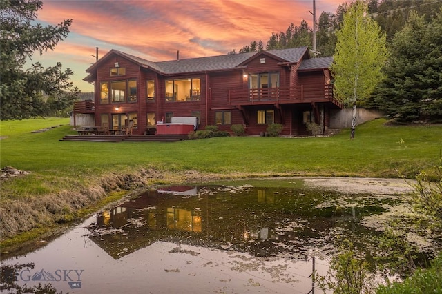 48042 Gallatin Rd, Big Sky, MT 59730 - rear view of house with a deck, a lawn, and a shingled roof