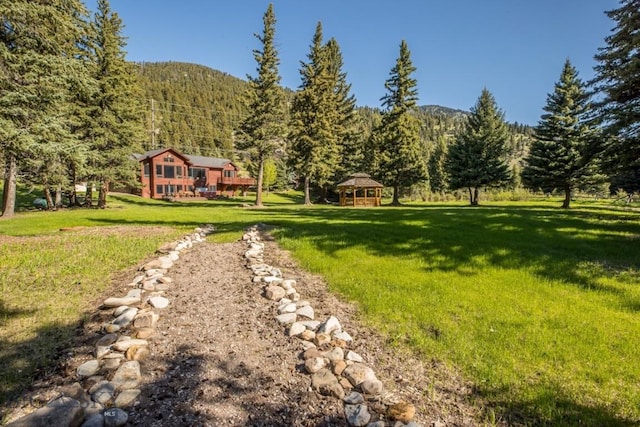 48042 Gallatin Rd, Big Sky, MT 59730 - view of grassy yard featuring a gazebo and a wooded view