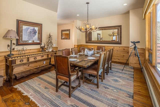 48042 Gallatin Rd, Big Sky, MT 59730 - dining space featuring hardwood / wood-style floors, a chandelier, recessed lighting, wainscoting, and a baseboard heating unit