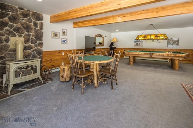 48042 Gallatin Rd, Big Sky, MT 59730 - game room with wainscoting, carpet, a wood stove, beamed ceiling, and a baseboard heating unit