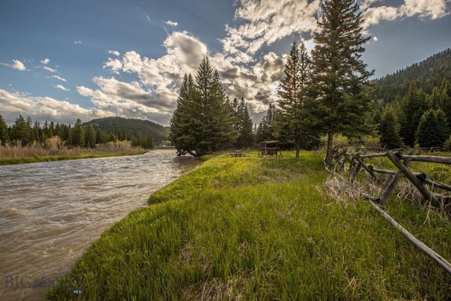 48042 Gallatin Rd, Big Sky, MT 59730 - water view featuring a forest and a mountainous background