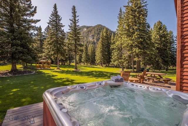 48042 Gallatin Rd, Big Sky, MT 59730 - view of patio with an outdoor hot tub, a gazebo, and a deck with mountain view