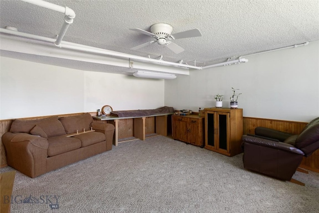 510 S Excelsior, Butte, MT 59701 - carpeted living area with a textured ceiling, a ceiling fan, a wainscoted wall, and wooden walls