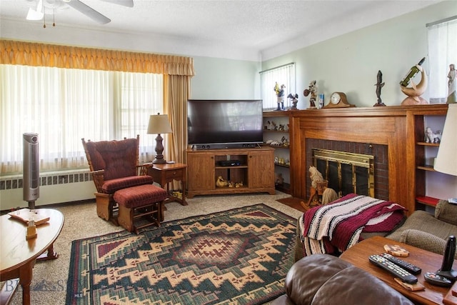 510 S Excelsior, Butte, MT 59701 - living area featuring radiator, a ceiling fan, carpet flooring, and a glass covered fireplace