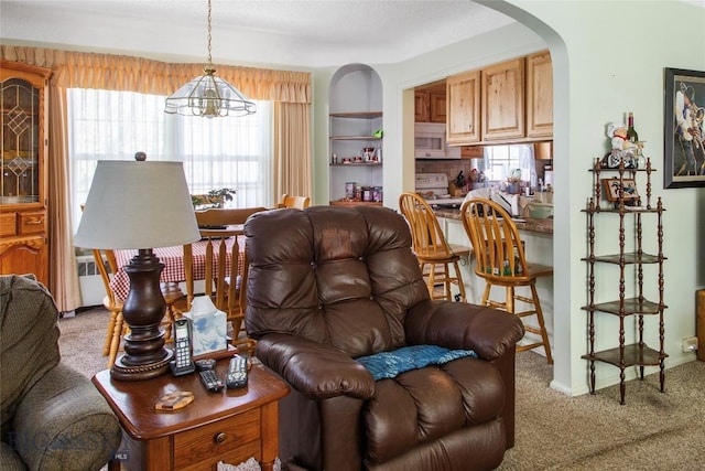 510 S Excelsior, Butte, MT 59701 - carpeted living room featuring arched walkways and a chandelier