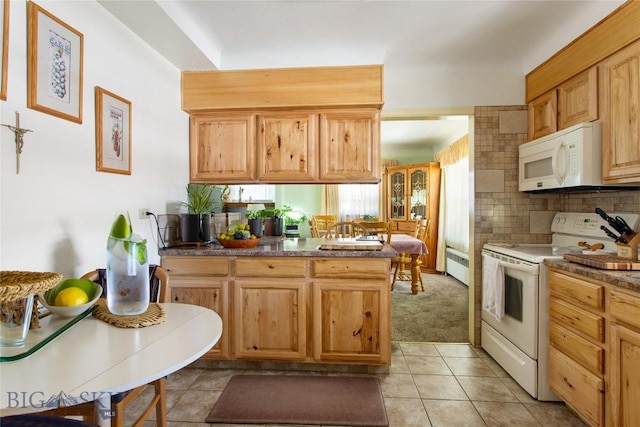 510 S Excelsior, Butte, MT 59701 - kitchen with white appliances, a peninsula, backsplash, radiator, and light tile patterned floors