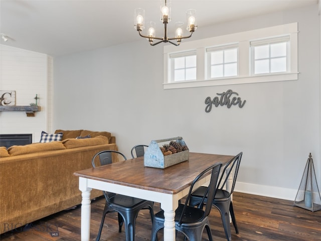 3171 Spring Ridge Dr, Bozeman, MT 59715 - dining room with a chandelier, dark wood-style floors, and a large fireplace