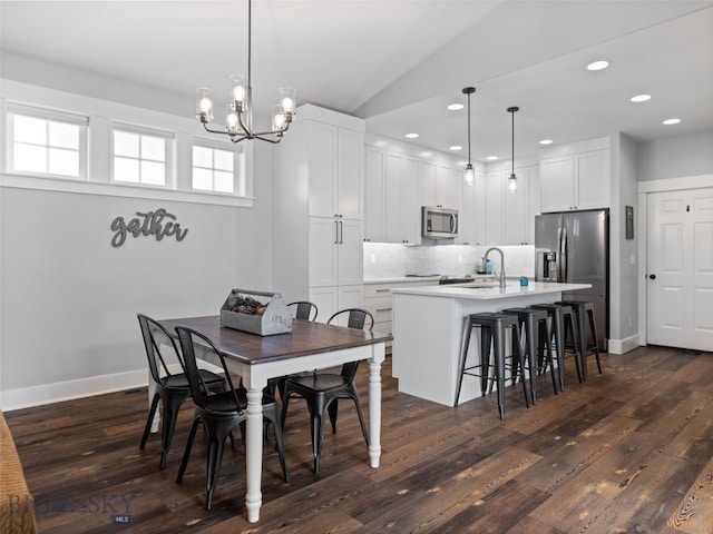3171 Spring Ridge Dr, Bozeman, MT 59715 - dining room featuring dark wood-style floors, a chandelier, recessed lighting, and lofted ceiling