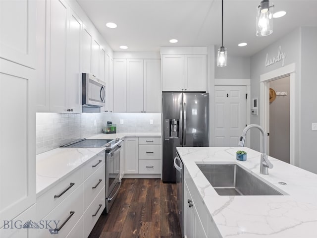 3171 Spring Ridge Dr, Bozeman, MT 59715 - kitchen featuring stainless steel appliances, white cabinets, dark wood-type flooring, and recessed lighting